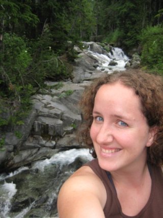 A picture of Elizabeth with a waterfall behind